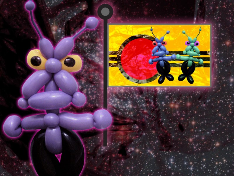 Purple balloon alien with yellow eyes stands before a flag with two balloon aliens against a starry background.